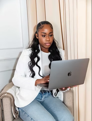 Tashana Cuffy seated with her laptop